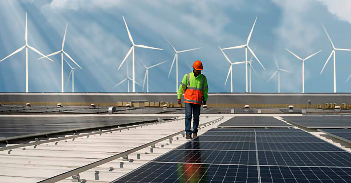 Image of a contractor among solar panels and wind turbines