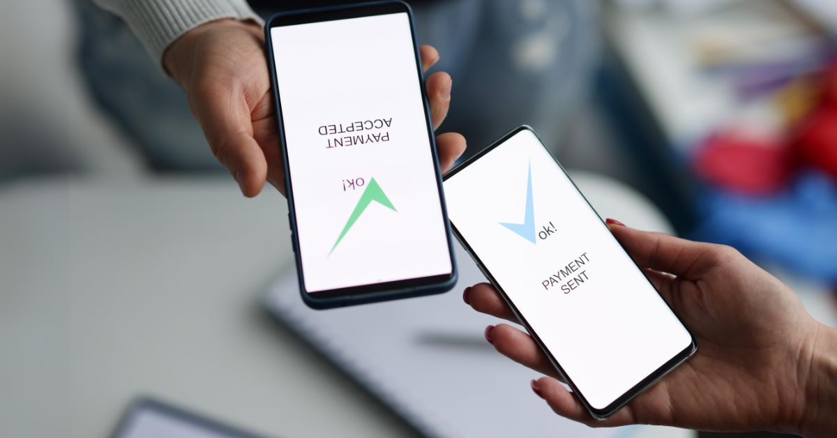 Image of hands holding phones with 'payment sent' and 'payment selected' on their screens