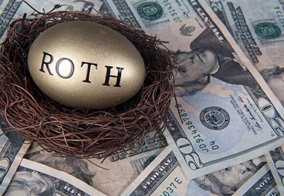 Image of a nest with a golden egg that says 'ROTH' placed in it, with money in the background