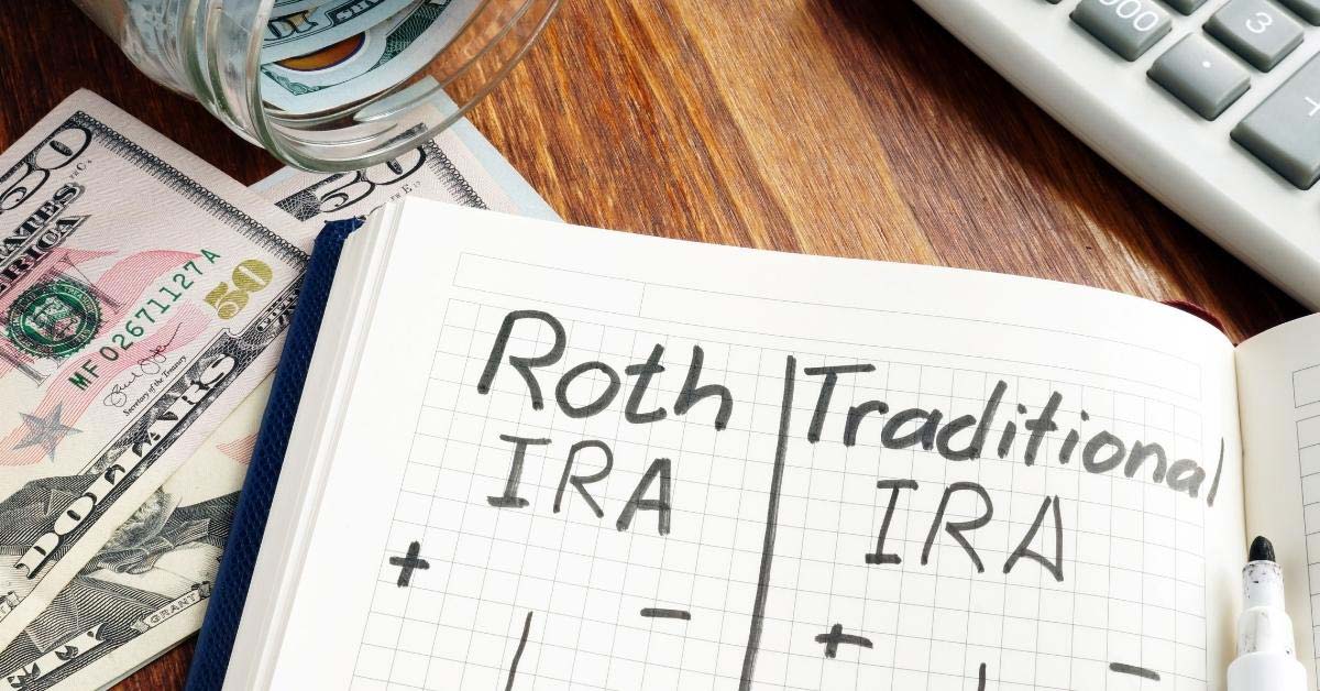 Image of a desk with money and a calculator with a notebook reading 'Roth IRA and Traditional IRA'