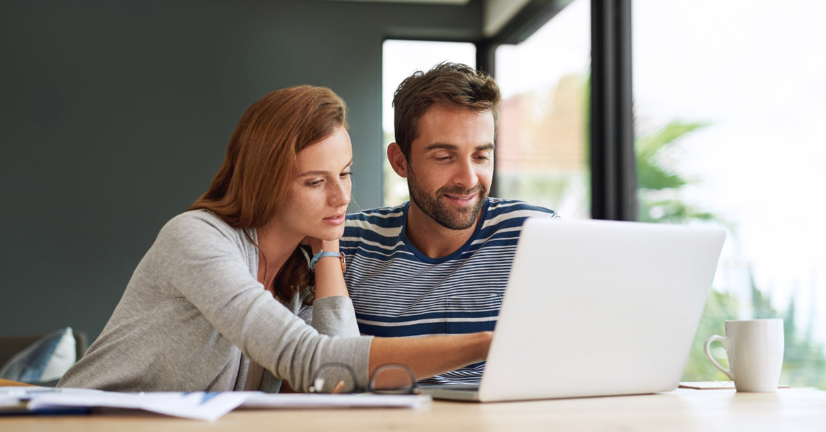 Image of a couple researching on their laptop
