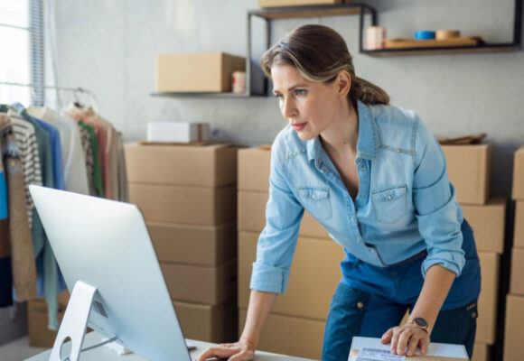 Image of a woman business owner looking at her computer