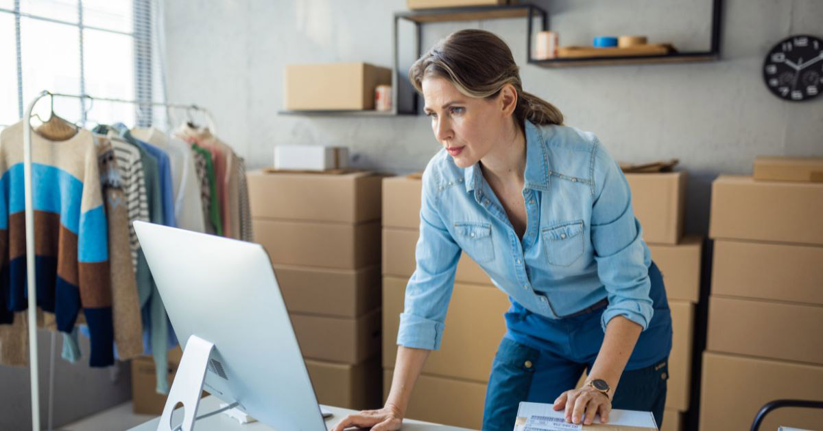 Image of a woman business owner looking at her computer