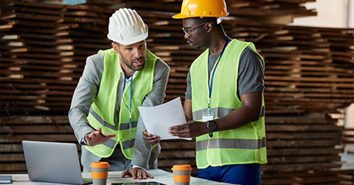 Image of construction worker and contractor going over numbers