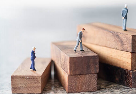 Image of toy blocks with dolls stepping up the block steps