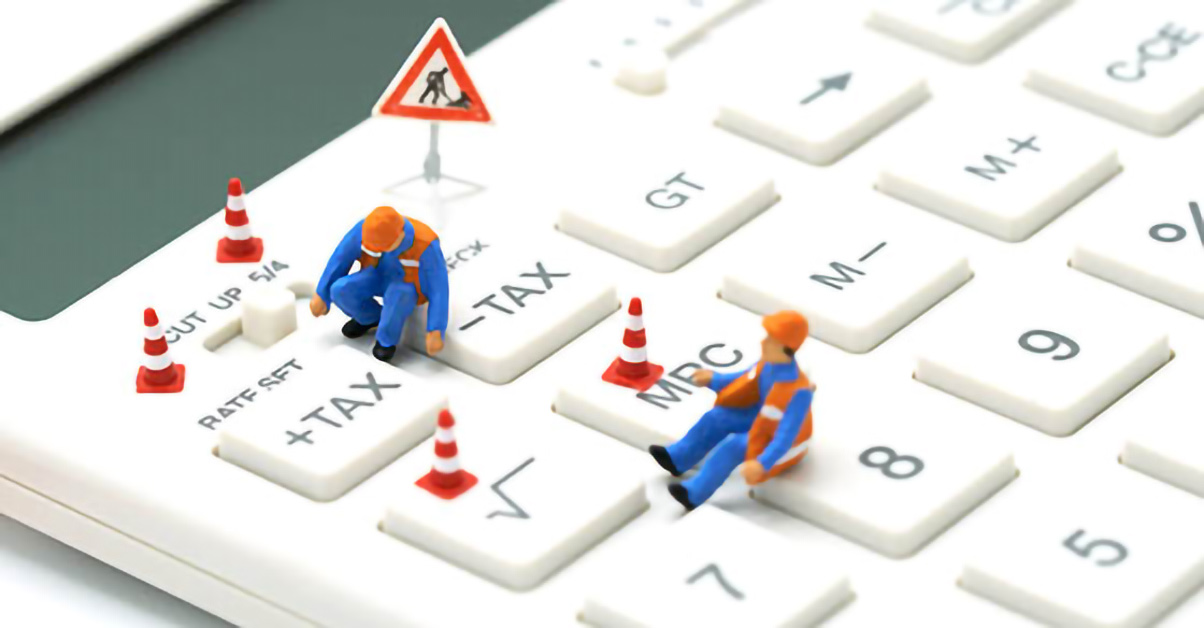 An image of a toy keyboard and small figures wearing construction hats