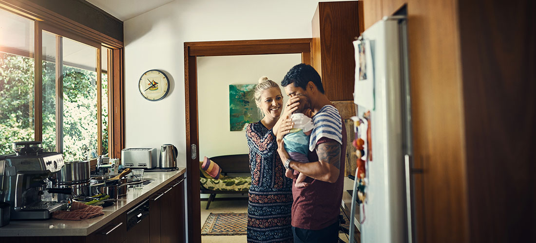 photo of new parents at home on Family and Medical Leave taking care of their newborn baby