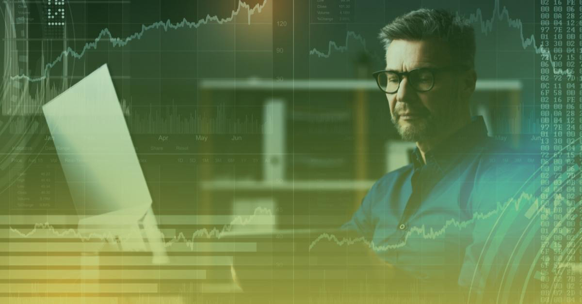 Image of a man in glasses doing research on his laptop