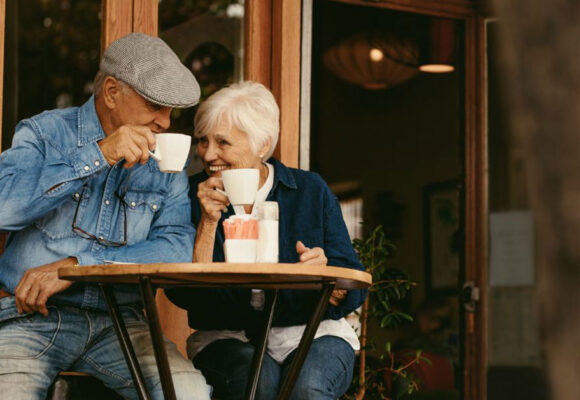 Image of retired folks enjoying coffe in a cafe