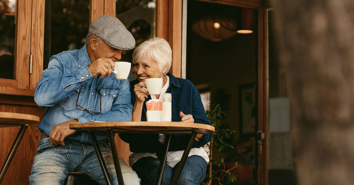 Image of retired folks enjoying coffe in a cafe