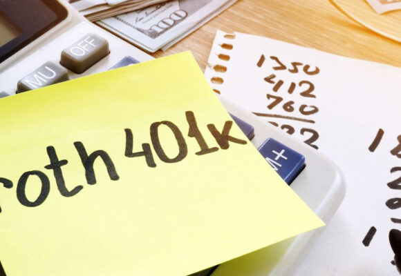 Image of a desk with money, and a sticky note that says 'roth 401k'