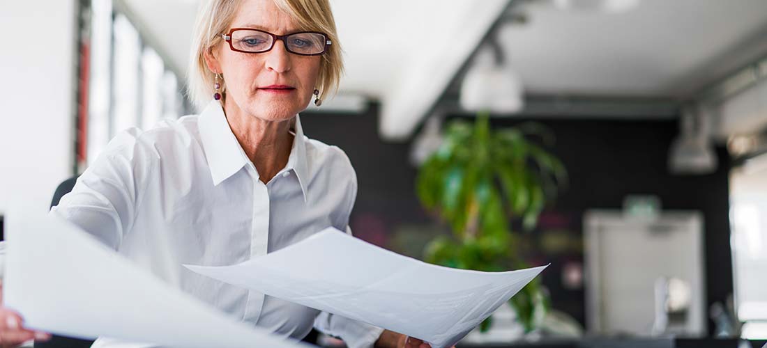 Business woman looking at C-Corp conversion reports